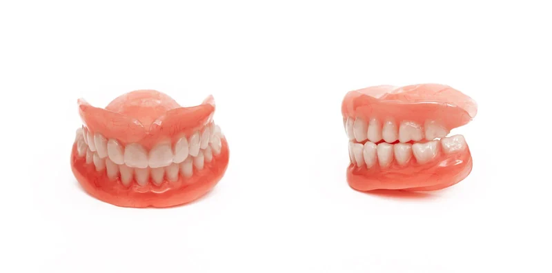Denture impression trays and precision tools laid out on a linen cloth
