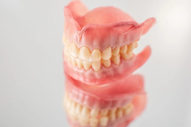 Close-up of a cast metal partial denture framework on soft linen