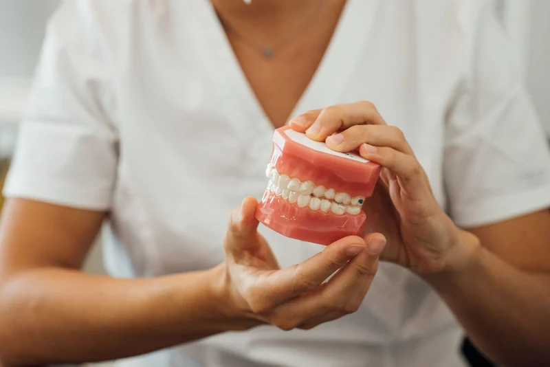 A full removable denture set resting on soft linen cloth